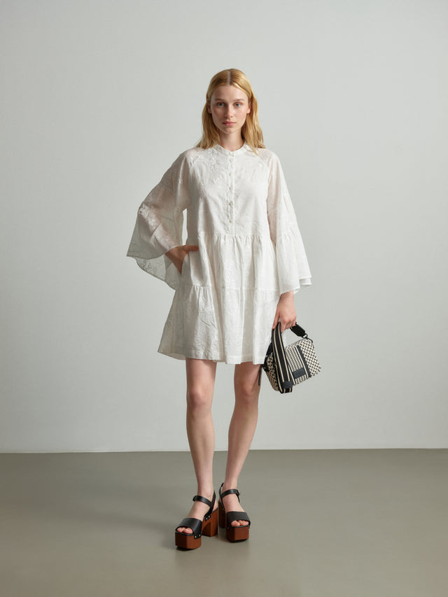 Dress Delmar magic garden embroidery white - Introducing Delmar, a caftan-inspired short dress in crisp white, crafted...
